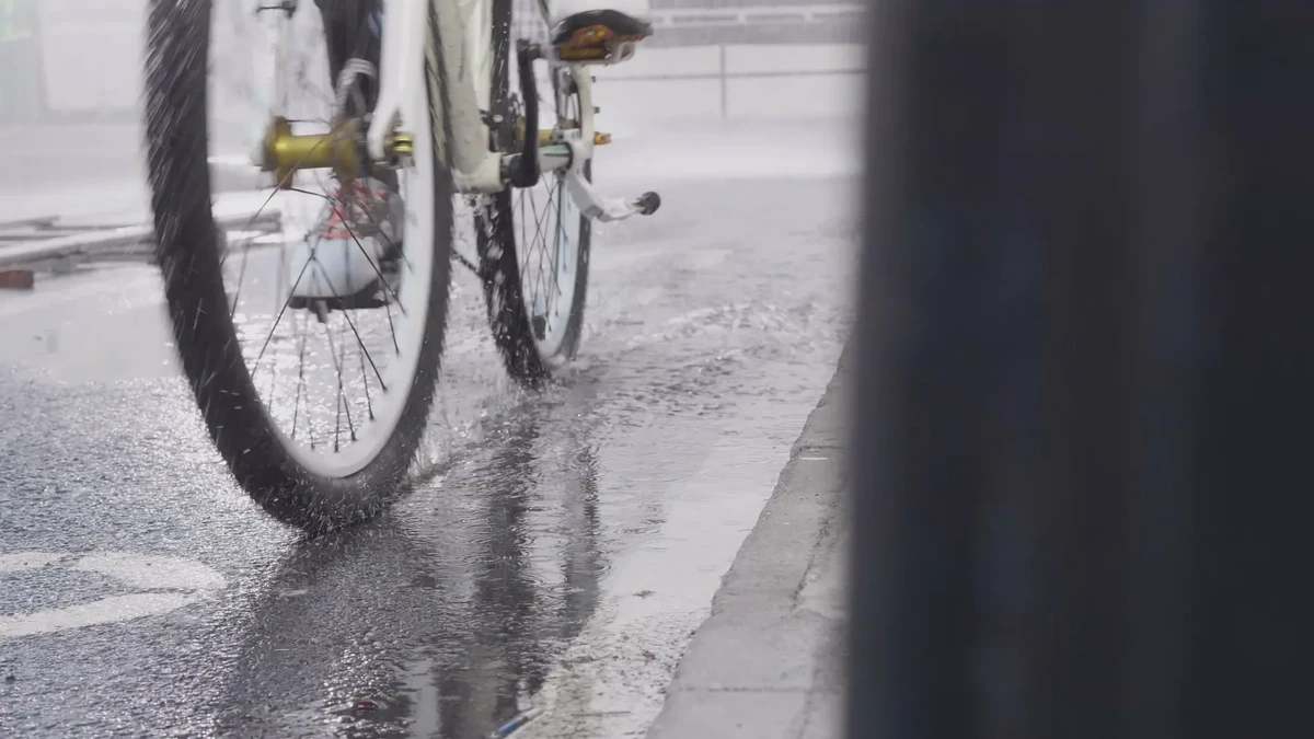 雨天街道上自行车轮经过积水的广告片画面