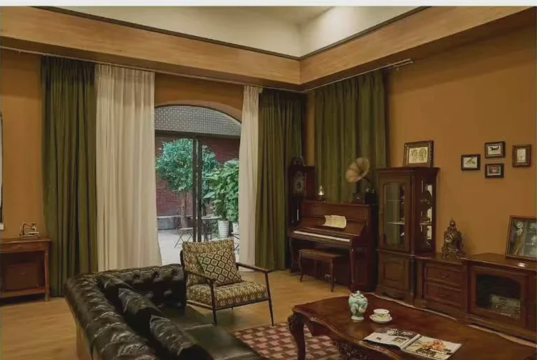 Warm vintage American living room with leather seating, piano and dark timber furniture