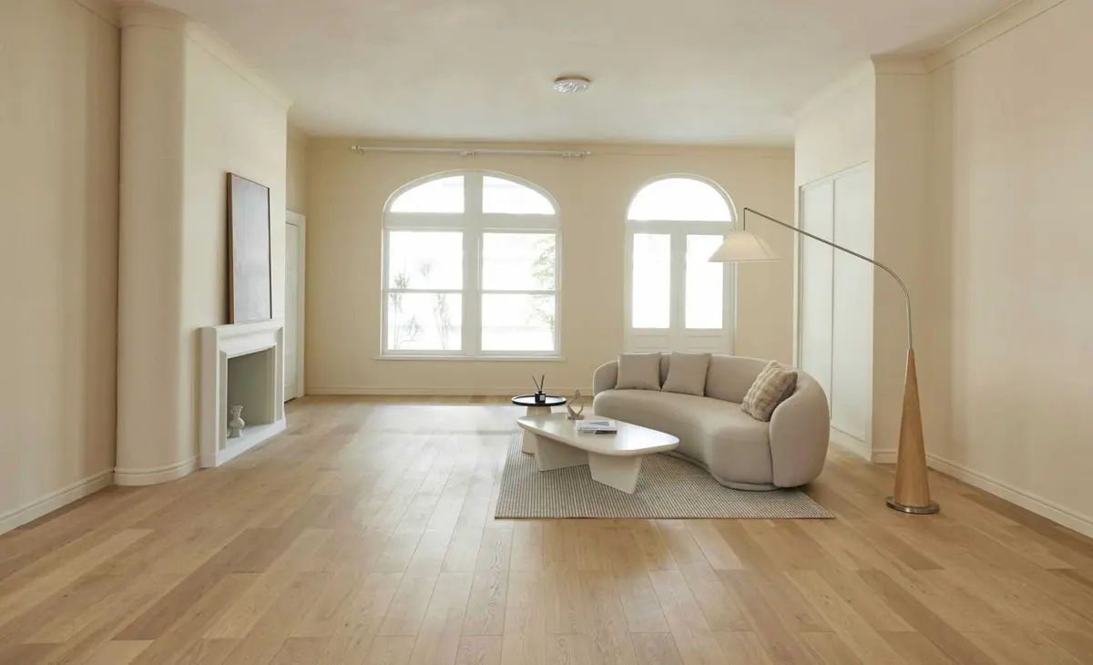 U&P SPACE living room with arched windows, a cream sofa and pale timber flooring