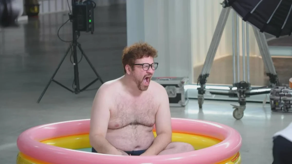 Behind the scenes of the undun brand film: performer sitting in an inflatable pool